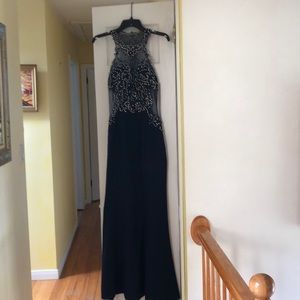 Navy gown with sheer top appliqués.